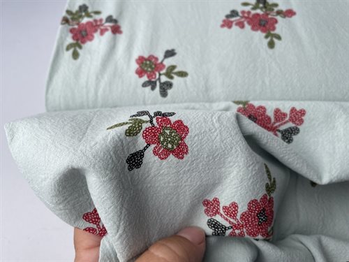 Fastvævet bomuld - smukke blomster på mint bund